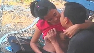 Desi boyfriend fondles his girlfriend's large breasts on a park bench