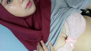 Indian girl in hijab reveals her breasts and engages in sexual activity