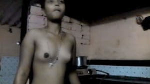 A slender girl undressing in the bathroom