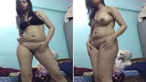 Exotic Indian girl with a seductive look performs a money dance striptease