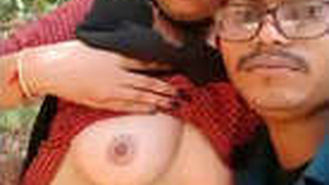 A South Asian couple basks in the sun as they pleasure each other with tit sucking in a rural setting