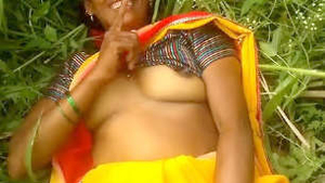 Indian bhabhi's outdoor boob play in village