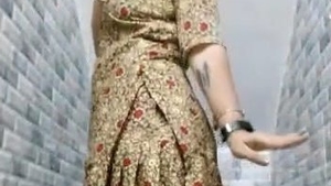 A curvy South Asian woman showcases her ample bosom