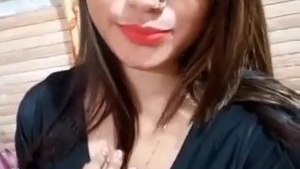 An attractive young woman from South Asia reveals her breasts and intimate area