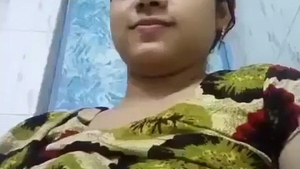Watch as a busty woman flaunts her breasts in the shower