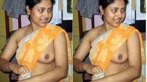 Desi girl with small boobs teases in a tank top, revealing her pride