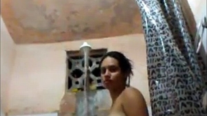 A young Indian woman uses a shower to achieve pleasure
