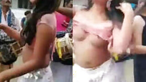 two whore nude dance in village, public place, infront of people