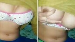 Lovely Indian pulls yellow top up exposing XXX melons with nipples