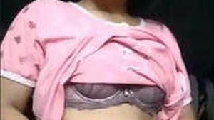 Aroused African American woman undresses and seductively poses in this heated recording