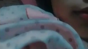 A young woman's breasts are fondled during a sexual encounter