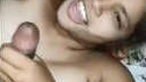 A blonde woman pleases her partner with a sensual oral sex act and engages in sexual play with his penis