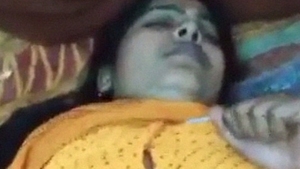 Watch a mature auntie in yellow sari in a steamy video