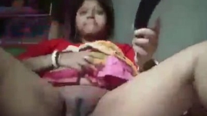 Aroused Indian woman pleasures herself with a large cucumber